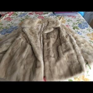 Lined short beige colored fur coat